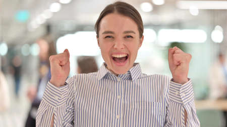 Portrait of Excited Young Woman Celebrating Successの写真素材