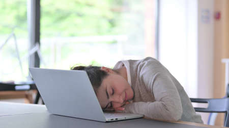 Tired Young Indian Woman Sleeping on Laptop