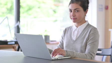 Disapproving Young Indian Woman with Laptop showing No Signの写真素材