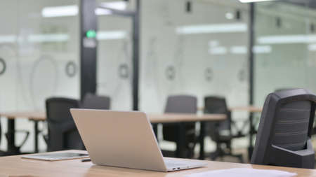 Empty Business Office with Open Laptopの写真素材