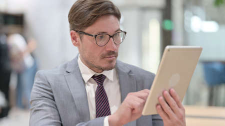 Portrait of Businessman using Digital Tabletの写真素材