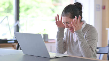Young Indian Woman with Laptop Screaming, Shouting