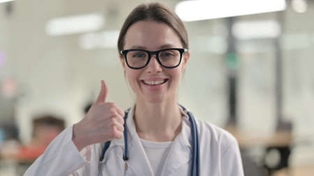 Portrait of Young Female Doctor showing Thumbs Up Signの写真素材