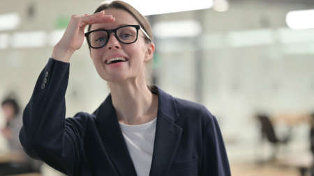 Portrait of Curious Young Businesswoman Looking Around, Searchingの写真素材