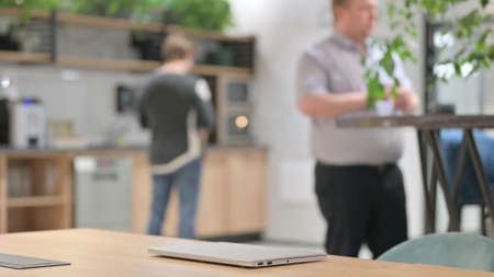 Closed Laptop on Desk after Woman Left the Officeの写真素材