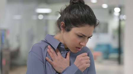 Portrait of Sick Young Indian Woman Coughingの写真素材