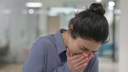 Portrait of Young Indian Woman Sneezingの写真素材