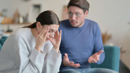 Man Fighting with Stressed Wife at Homeの写真素材