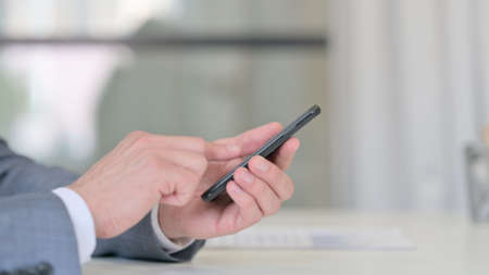 Close Up of Businessman Typing on Smartphone