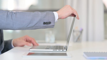 Close Up of Businessman Opening and Typing on Laptopの写真素材