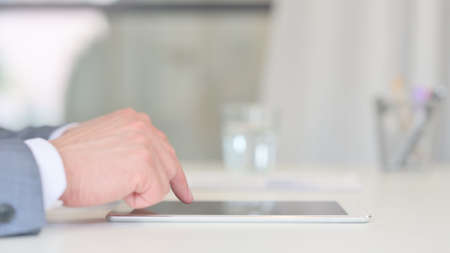 Hands Close up of Businessman working on Tablet