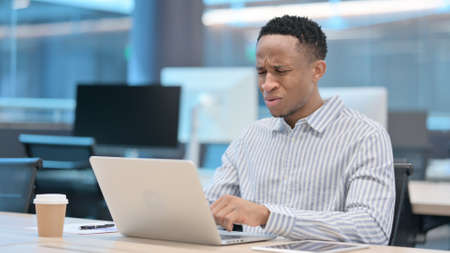African Businessman with Laptop having Loss, Failure