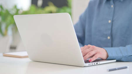 Close up Shot of Woman Typing on Laptop Keypadの写真素材