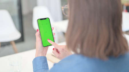 Woman Using Smartphone with Green Screen, Mock upの写真素材