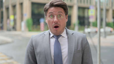 Middle Aged Businessman Feeling Shocked, Surprised Outdoorの写真素材