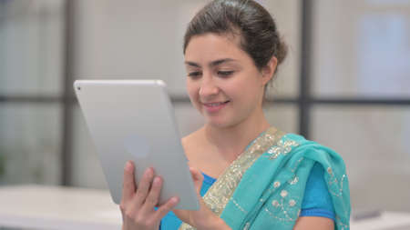 Portrait of Indian Woman using Tablet in Officeの写真素材
