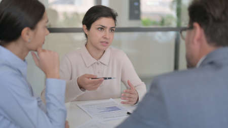 Indian Businesswoman With Reports Talking to Colleagues
