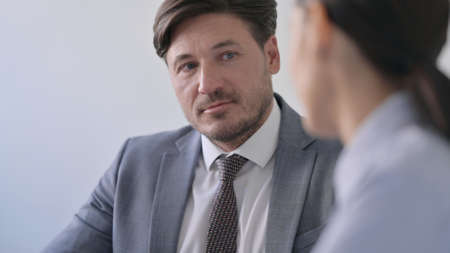 Close up of Businessman Talking to Teammatesの写真素材