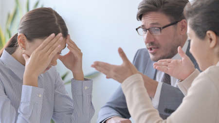 Angry Business People Scolding Female Colleagueの写真素材