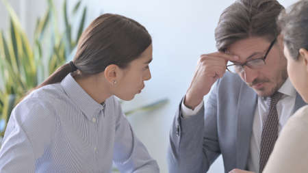 Angry Latin Businesswoman Talking to Colleagues