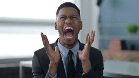Portrait of African Businessman Shouting, Screamingの写真素材