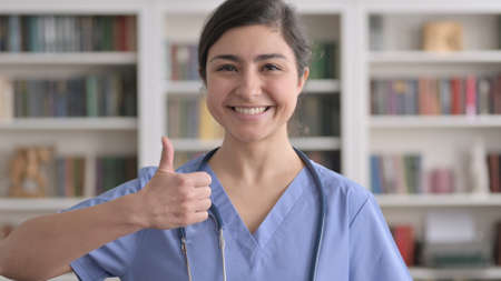 Portrait of Indian Female Doctor showing Thumbs Up Signの写真素材