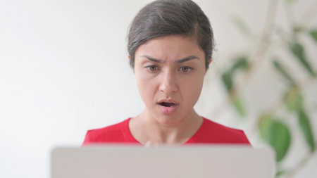 Close Up of Indian Woman Reacting to Loss While using Laptop