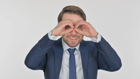 Young Businessman Searching with Handmade Binocular on White Screenの写真素材