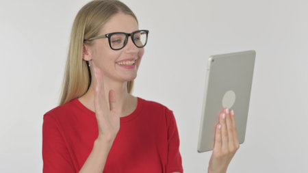 Video Call on Tablet by Casual Young Woman on White Backgroundの写真素材