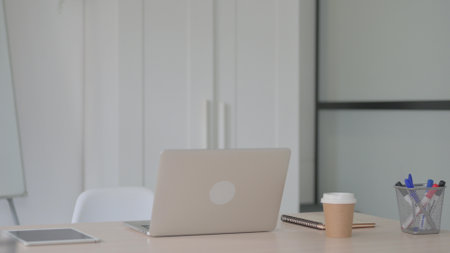 Empty Office with Open Laptop on Table