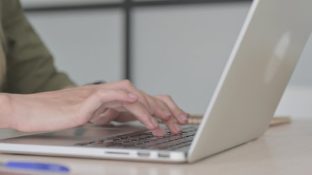 Close Up of Blonde Young Woman Typing on Laptop