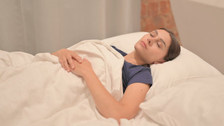Tired Young Latina Woman Sleeping in Bed at Home