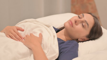 Tired Young Latina Woman Lying in Bed to Sleep