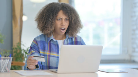 Young African Woman Upset by Online Payment Failure on Laptop