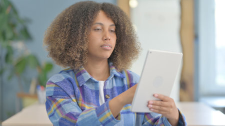 Portrait of Young African Woman using Tablet Computerの写真素材