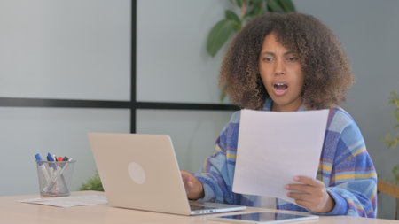 African American Woman Upset by Loss on Laptop and Documents, Contract