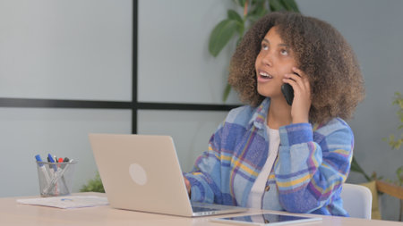 African American Woman Talking on Phone at work