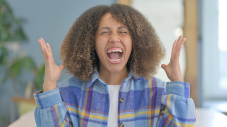 Portrait of Angry Young African Woman Screaming in Frustration