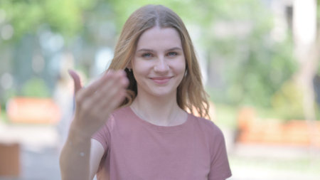 Outdoor Portrait of Young Woman Inviting New Peopleの写真素材