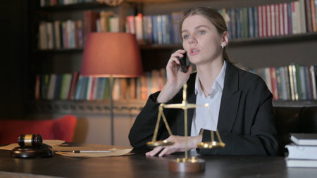 Female Lawyer Talking on Phone in Office