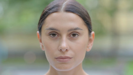 Close up of Serious Hispanic Woman Face Outdoorの写真素材