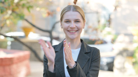 Outdoor Portrait of Applauding Businesswoman Cheering for Team