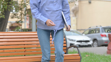 Tired Latin Woman Leaving Bench Outdoor after Closing on Laptop