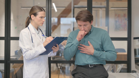 Coughing Female Patient Discussing Health issues with Doctorの写真素材