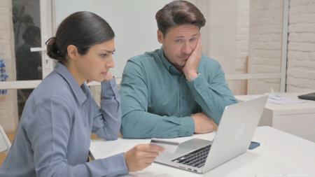 Mixed Race Business People Upset with Online Payment Failure in Office