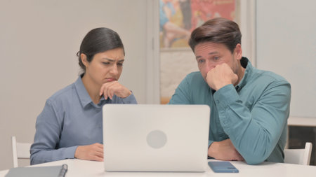 Indian Woman Reacting to Online Loss with Teammateの写真素材