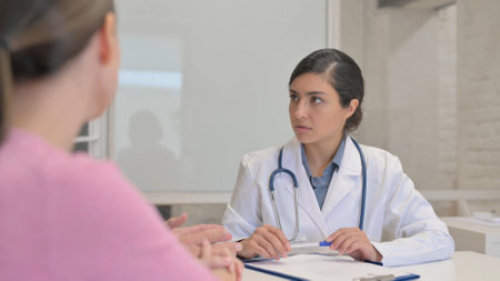 Close Up of Indian Female Doctor Listening Patientsの写真素材