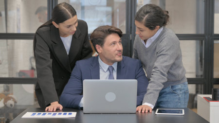Businessman Working with Teammate on Laptop