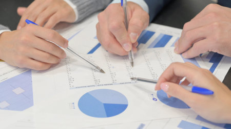 Close Up of Hands Doing Paperwork, Business Charts