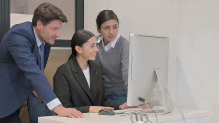 Hispanic Businesswoman Doing Video Chat on Computer with Teammates